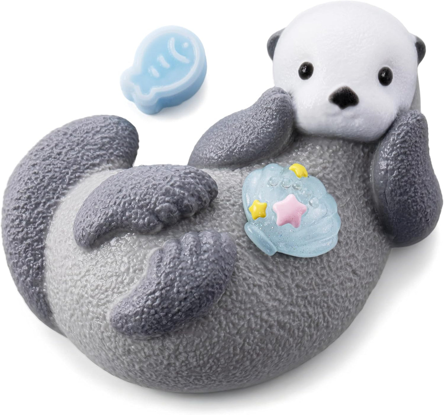Kawaii sea otter squishy floating on its back holding a shell