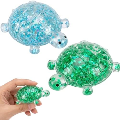 Two glitter turtle squishies in blue and green with stars