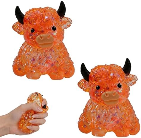 Two orange crystal jelly highland cow squishies