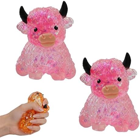 Two pink sparkly crystal highland cow squishies