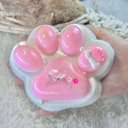Big pink cat squishy paw with bow and pearls, slow rising stress toy