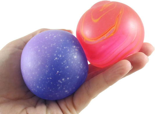 Two galaxy squishy ball stretch gel toys held in hand