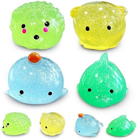 Four glitter sea animal mochi squishy toys including a whale and dolphin