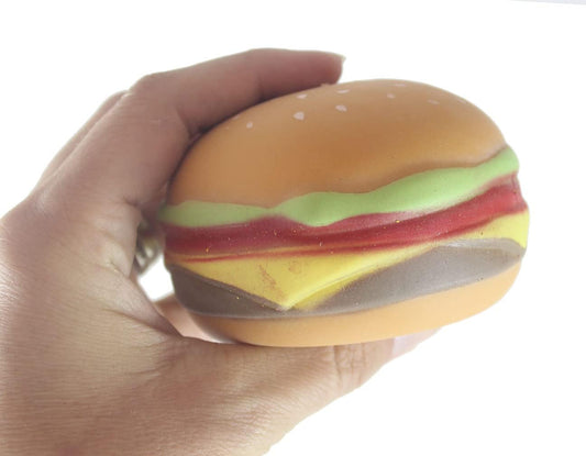 Single realistic hamburger squishy squeeze ball held in a hand