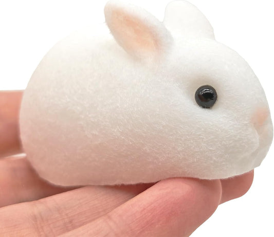 Soft white flocked mini bunny mochi squishy held in a hand
