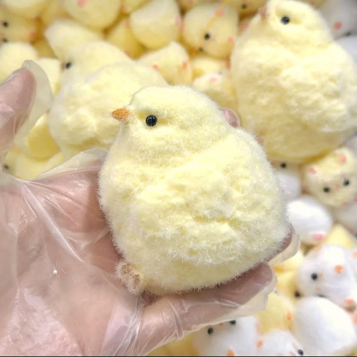 Handmade fuzzy yellow chick squishy held in hand