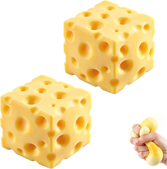 Two yellow cheese squishy cubes with deep holes