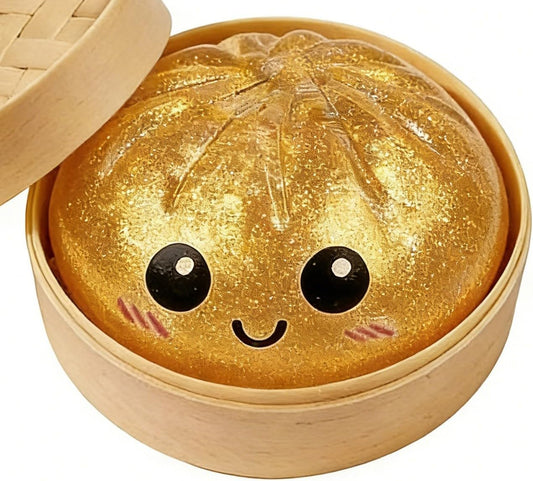 Gold glitter dumpling squishy with a smiley face