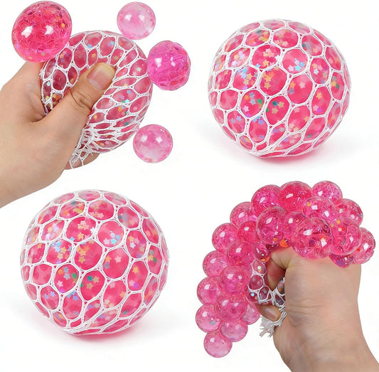 Pink glitter mesh squishy ball squeezed into shiny bubbles by hand