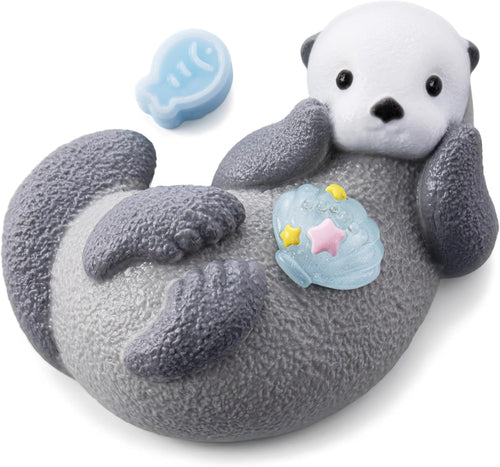 Kawaii sea otter squishy floating on its back holding a shell