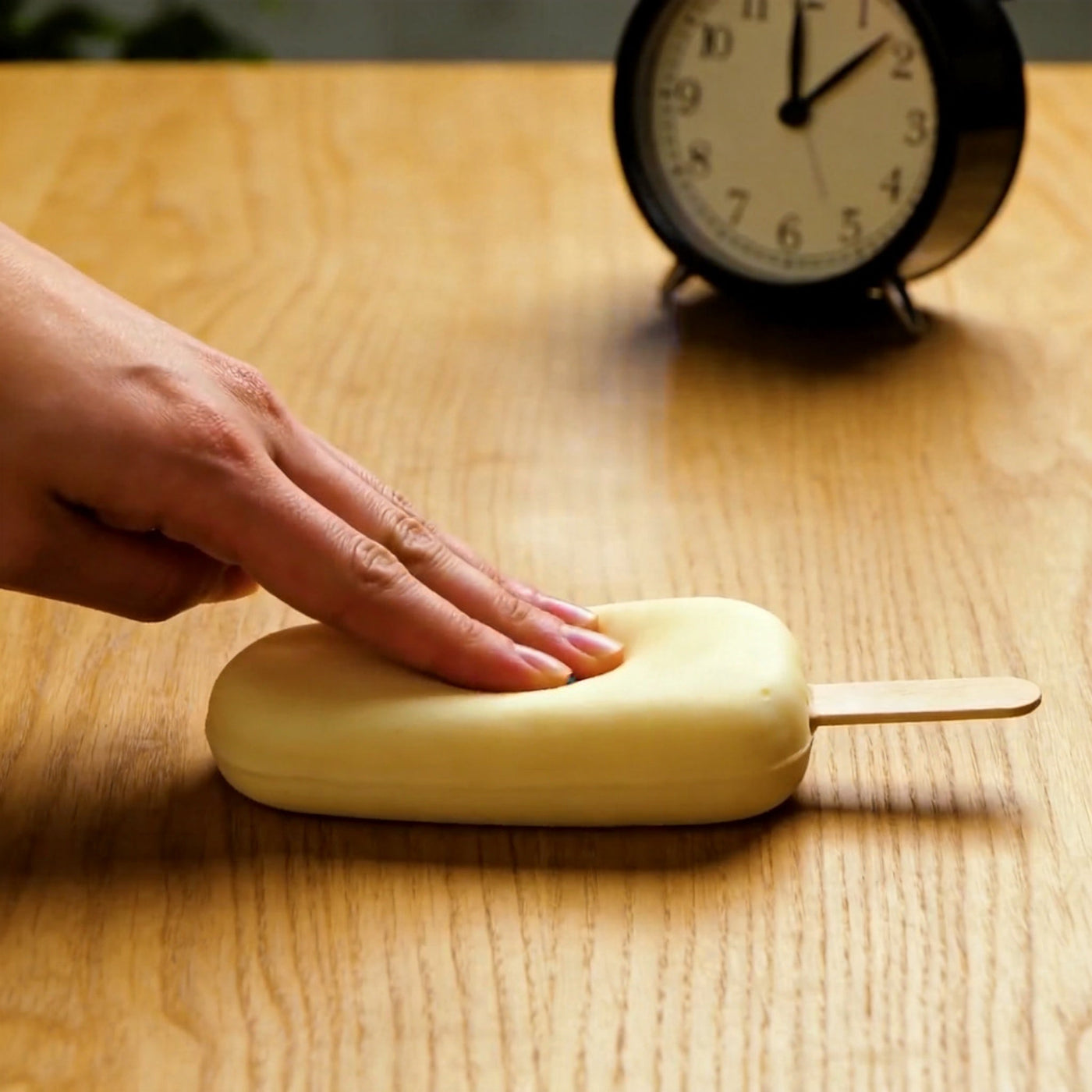 A popsicle squishy slowly rising after being pressed flat