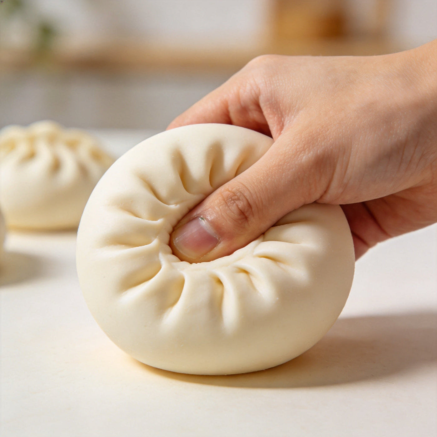 Hand squeezing a dumpling squishy