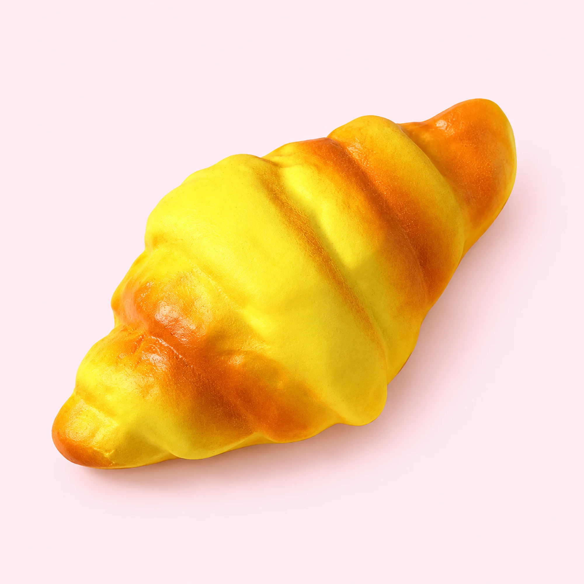Golden Croissant Squishy in the selected supplier design on a pale pink background