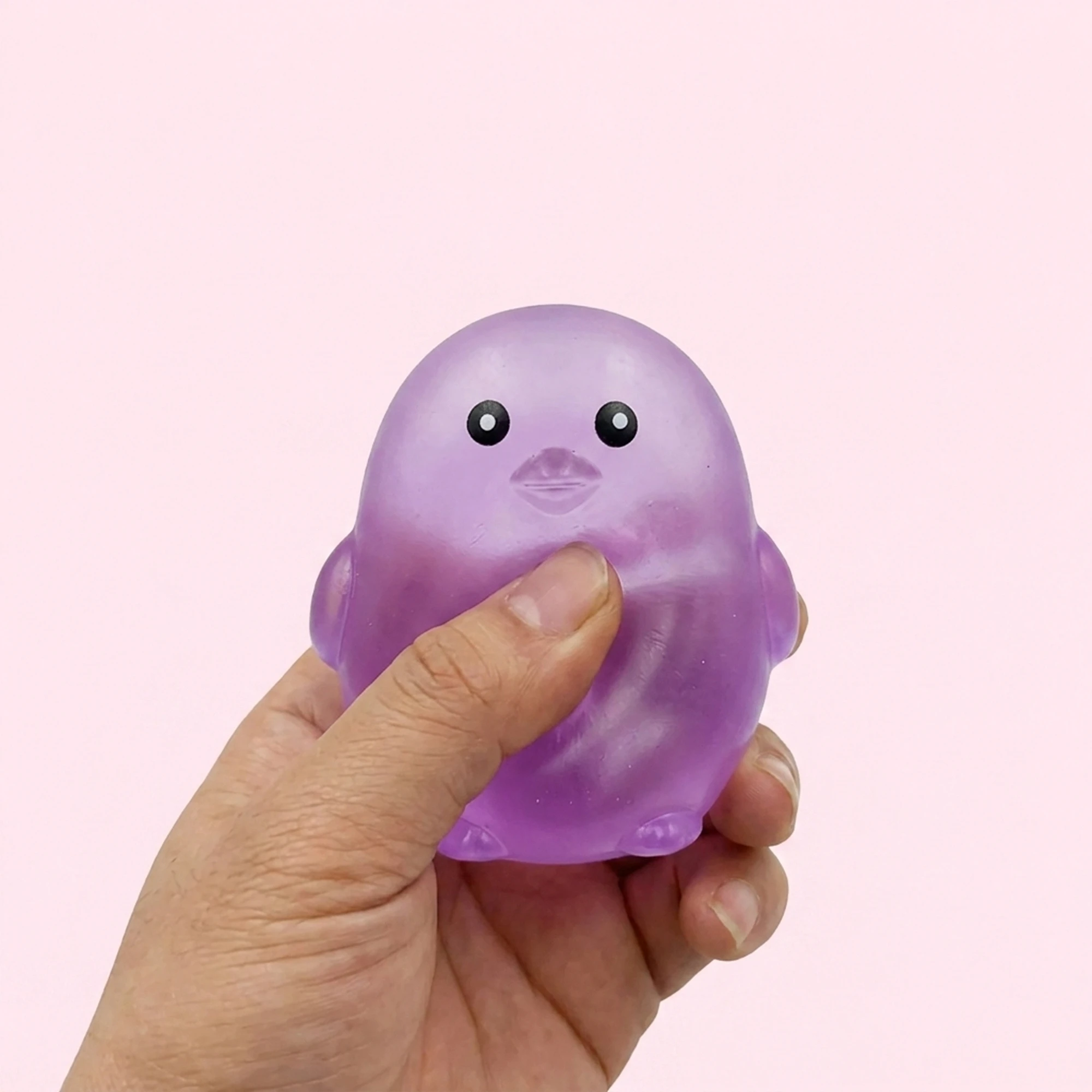 Purple chick squishy ball on a pale pink background