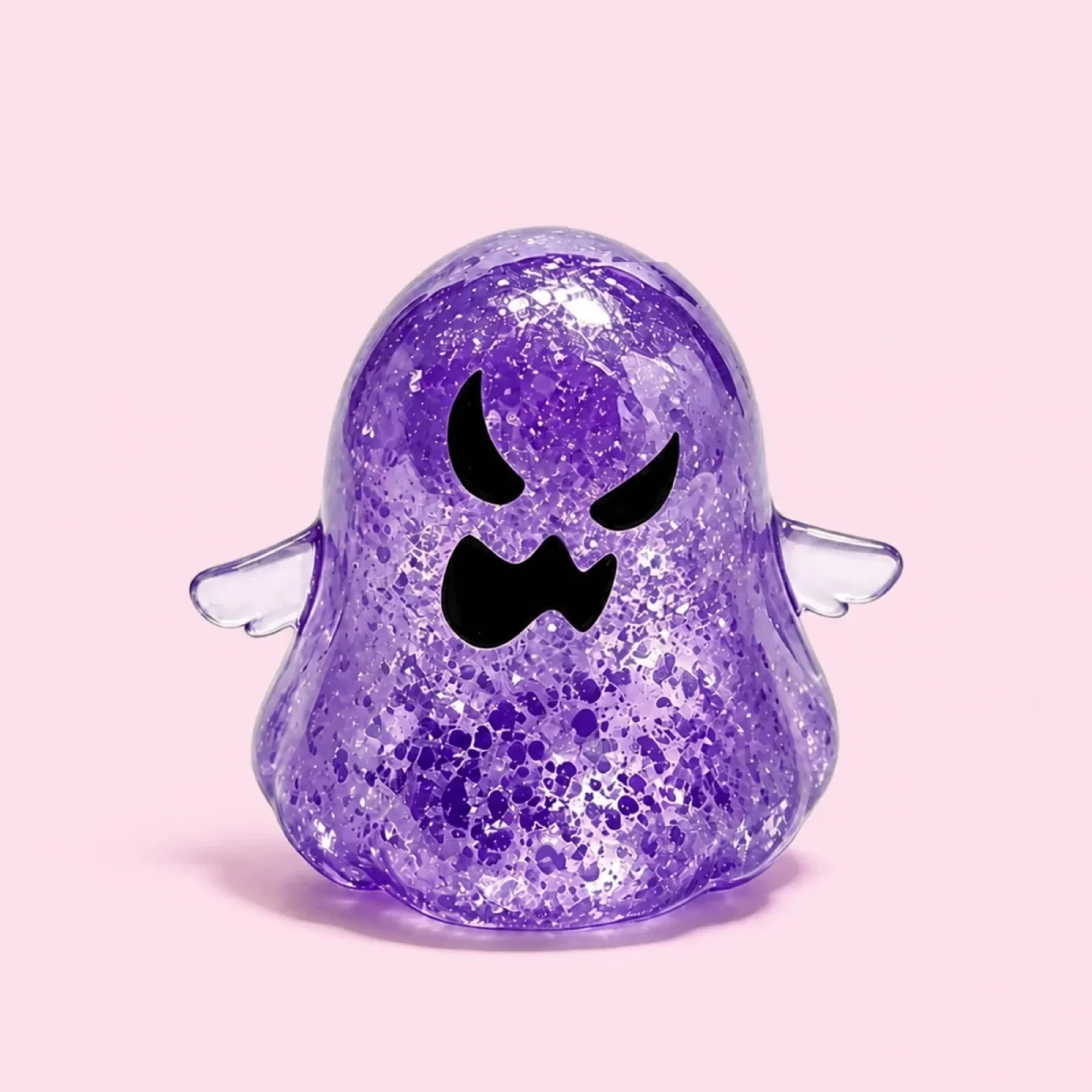 Purple glitter ghost squishy on a pale blush pink background