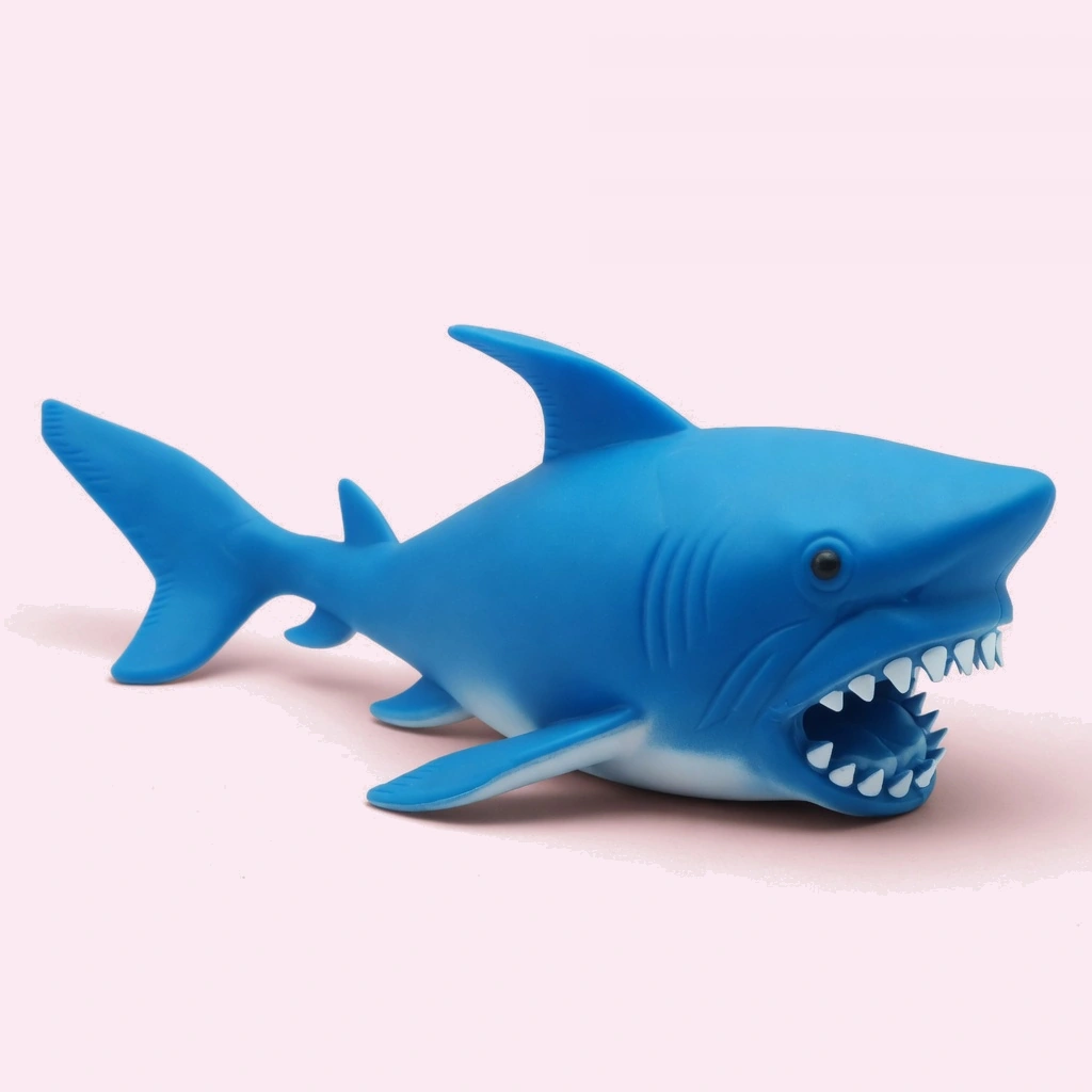 Soft blue shark squishy stress ball held in hand