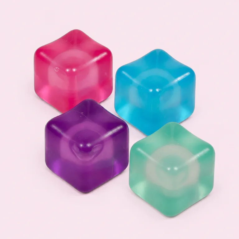 Child using wooden tongs to grasp and sort ice cube squishies into matching color bowls