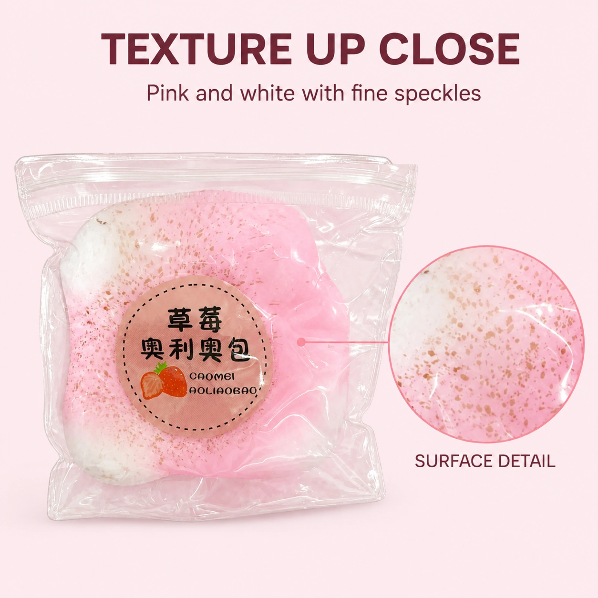 Pink and white mochi squishy with visible speckled surface detail
